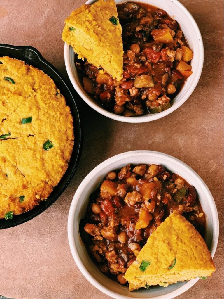 Delicious cornbread served with hearty chili in two bowls, perfect for comfort food lovers and ideal for a cozy meal.