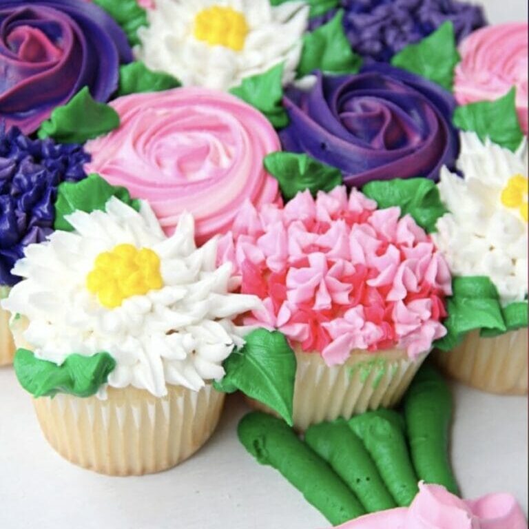 Decorative cupcake bouquet with colorful floral frosting designs for special occasions.