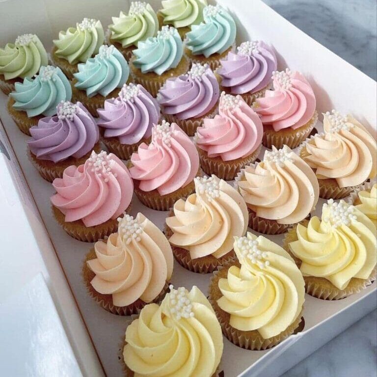 Colorful swirl cupcakes with sprinkles in pastel shades, perfect for cake decorating and bakery supplies from Over the Top Cake Supplies.