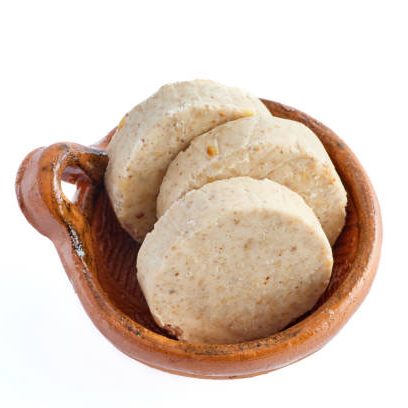 Close-up of traditional Mazapan and Abuelita cookies in a small ceramic bowl, perfect for baking and decorating with cake supplies.