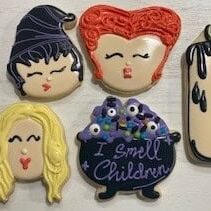Colorful themed decorated cookies with cartoon faces, makeup, and fashion-inspired designs from Over the Top Cake Supplies for creative cake decorating.