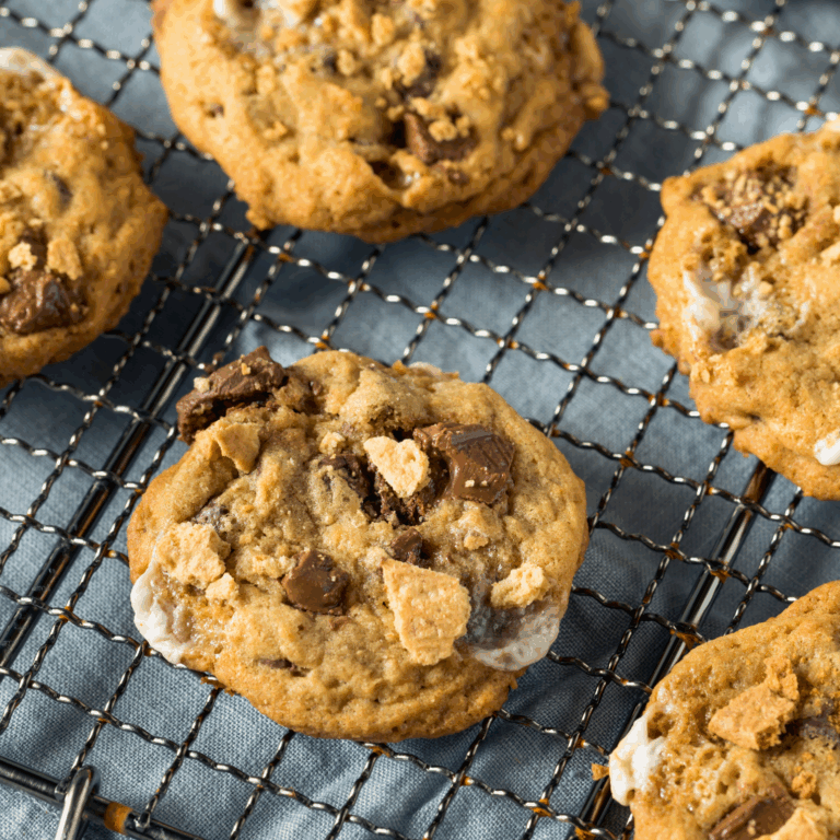 Delicious homemade chocolate chip cookies on a cooling rack, perfect for baking supplies from Over the Top Cake Supplies. High-quality baking tools for cookie, cake, and dessert decorating enthusiasts.