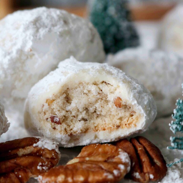 wedding cookies 13 Cream-filled Christmas snowball cookies with pecans, powdered sugar, and holiday decorations for festive baking.
